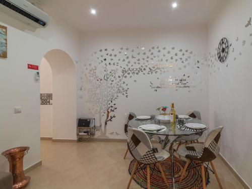 a dining room with a table and chairs at Holiday Home Felicidade by Interhome in Olhão