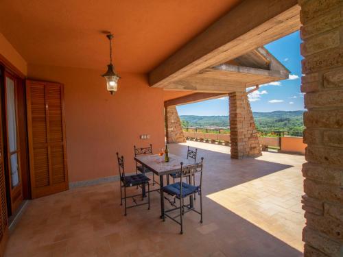 a dining room with a table and chairs with a view at Villa Villa Carolina by Interhome in Sutri
