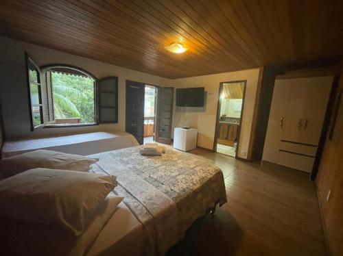 Posteľ alebo postele v izbe v ubytovaní Suites da Cabana