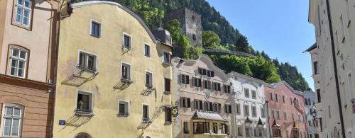 a group of buildings in front of a mountain at Boutiquehotel Rattenberg in Rattenberg