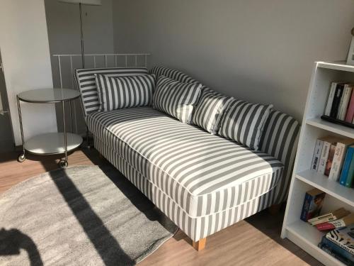 a couch with striped pillows in a living room at Ferienhaus Eckeweg 1 in Waldeck