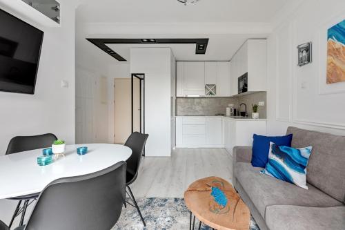 a living room with a couch and a table at GRANO APARTMENTS Gdańsk Old Town SPA & Wellness - GRANO APARTMENTS Gdańsk Residence SPA & Wellness in Gdańsk