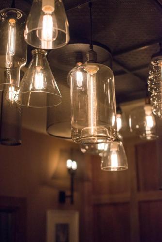 a group of glass lights hanging from a ceiling at Forest in Burnley