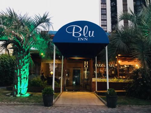 a building with a blue inn sign in front of it at Blu Inn in Punta del Este