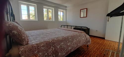 a bedroom with a bed and two windows at Nomad Villa Santa Fe in Las Palmas de Gran Canaria