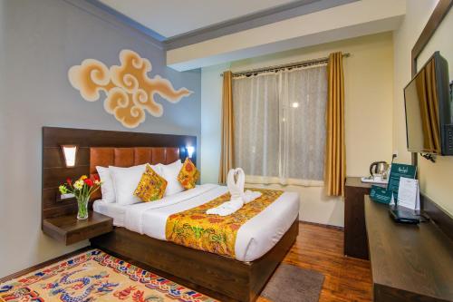 a bedroom with a large bed and a window at Muscatel Grand Silkroute - 300 Mts from MG Marg in Gangtok