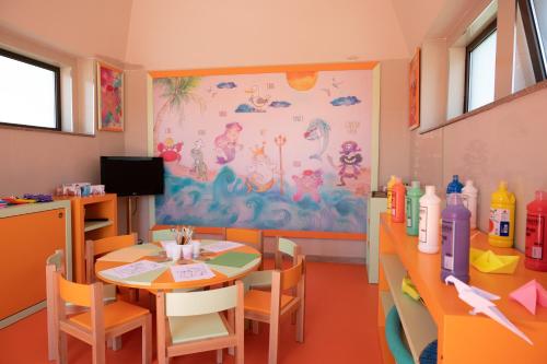 a childrens dining room with a table and chairs at Vila Gale Collection Alter Real - Resort Equestre, Conference & Spa in Alter do Chão