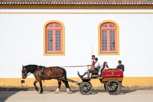 a horse pulling a cart full of people at Vila Gale Collection Alter Real - Resort Equestre, Conference & Spa in Alter do Chão