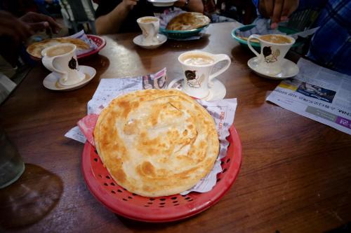 a pie on a red plate on a table at Hotel Grace inn in Multan