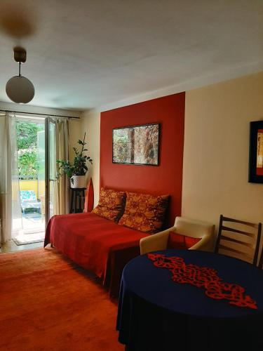 a bedroom with red walls and a bed and a window at City terrace-apartment in Vienna