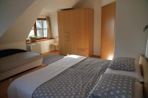 a bedroom with a large bed and a dresser at Villa Schnuck - das rote Ferienhaus in Bad Gastein