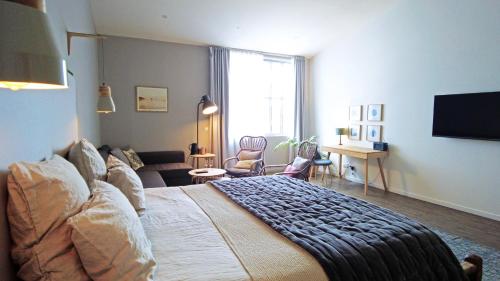 1 dormitorio con 1 cama grande y sala de estar en Les Chambres de l'Imprimerie, en Beaune