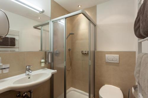 a bathroom with a shower and a sink at Apart-Hotel Alpinsonnenresidenz in Fiss