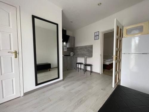 a living room with a mirror and a kitchen at Gusarskiy Hotel and Apartment in Kyiv