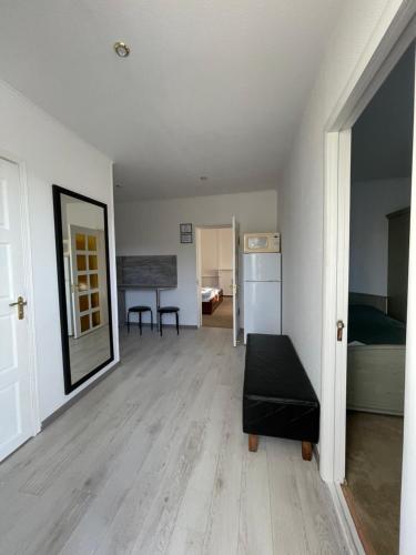 an empty living room with a couch and a bedroom at Gusarskiy Hotel and Apartment in Kyiv