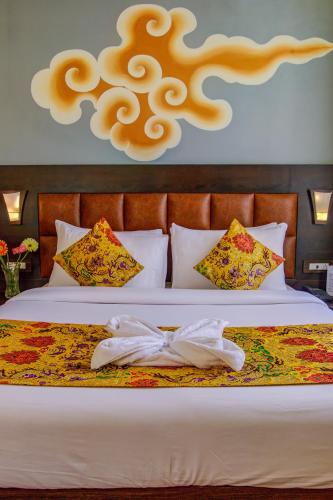 a bedroom with a bed with a robe on it at Muscatel Grand Silkroute - 300 Mts from MG Marg in Gangtok