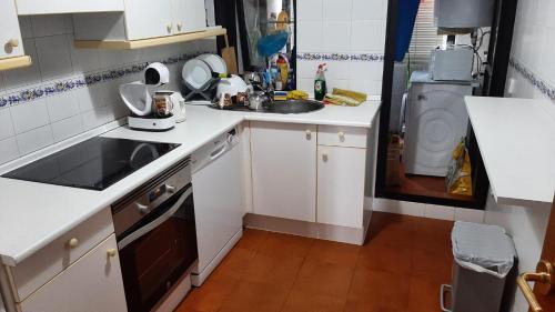 a small kitchen with a sink and a washing machine at Estupendo apartamento en San Vicente do Mar O Grove in San Vicente do Mar