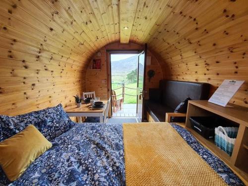 a bedroom with a bed in a wooden room at Gorse Hill Glamping in Newcastle