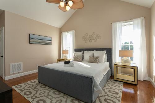 a bedroom with a large bed and a ceiling fan at Mountain Shadows BRAND NEW Luxurious House with Heated Pool - Games - And More Near Asheville! in Leicester