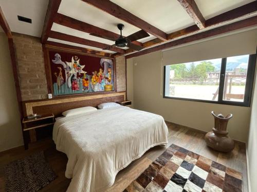 a bedroom with a large bed and a window at Casa en Los Castaños, Tafí del Valle in Tafí del Valle