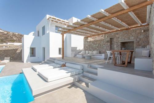 a villa with a swimming pool and a patio at Bellevue Villas in Plaka