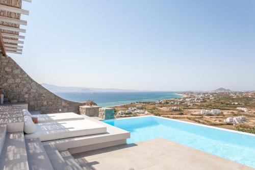 a swimming pool with a view of the ocean at Bellevue Villas in Plaka