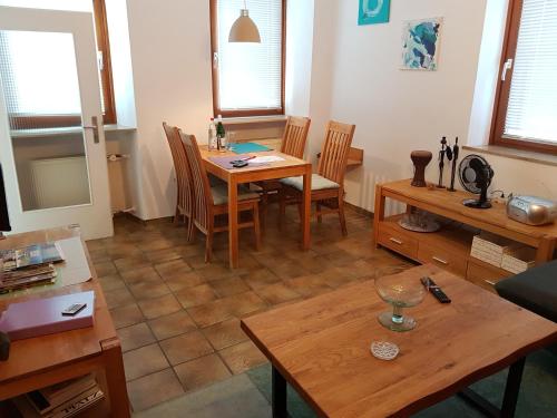 a living room with a wooden table and chairs at Gemütliches Stadthaus im Herzen der Altstadt in Bad Dürkheim