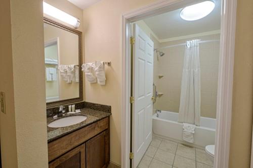 a bathroom with a sink and a shower and a mirror at Staybridge Suites Harrisburg-Hershey, an IHG Hotel in Harrisburg