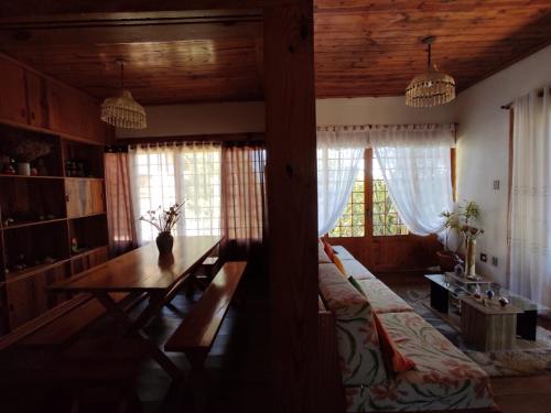 a living room with a table and a couch at Casa com vista verde in Ouro Preto
