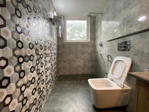 baño con aseo y lavabo y ventana en Manaslu en Gangtok