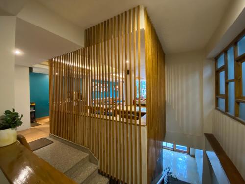 a lobby with a wooden partition with a pool in it at Manaslu in Gangtok