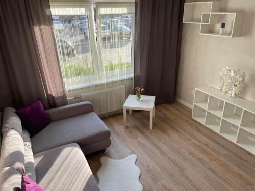 a living room with a couch and a table at PaulMarie Apartments on Kozlova, 1A/2 in Salihorsk