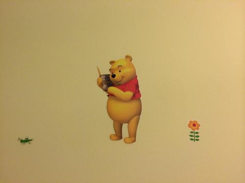 a teddy bear holding a bee on a wall at Hotel Parco Delle Rose in San Giovanni Rotondo