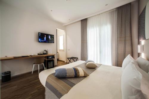 a hotel room with two beds and a desk at NOHA Lifestyle Hotel - Adults Only in Pula
