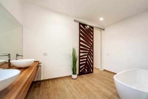 a bathroom with two sinks and two toilets at NOHA Lifestyle Hotel - Adults Only in Pula
