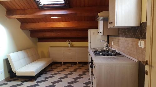 a kitchen with a stove and a couch in it at Central Suites Catania in Catania