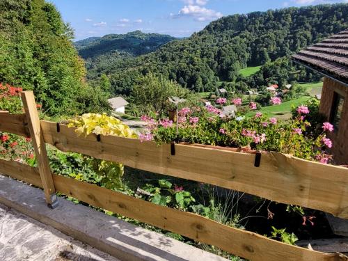 a wooden fence with a bunch of flowers at Farm ,zidanica ,JOLI in Gorica pri Slivnici