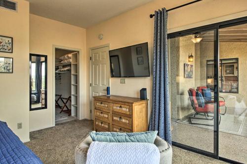 a living room with a tv and a couch at Oro Valley Getaway with Patio, BBQ and Mountain Views! in Oro Valley