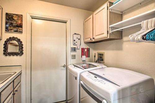 a small kitchen with a sink and a washing machine at Oro Valley Getaway with Patio, BBQ and Mountain Views! in Oro Valley