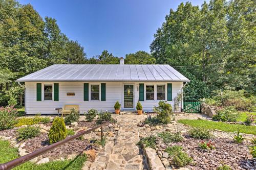 a small white house with a metal roof at Charming Cottage Less Than 10 Mi to Wineries and Skiing! in Nellysford