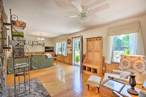 a living room with a couch and a ceiling fan at Charming Cottage Less Than 10 Mi to Wineries and Skiing! in Nellysford