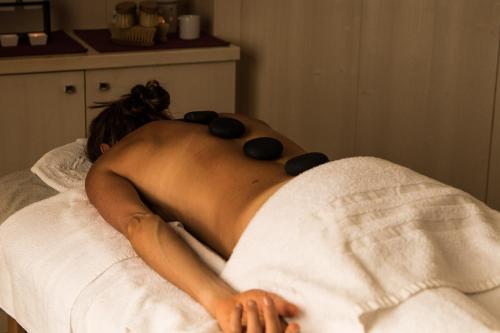 a nude woman laying on a bed withotherapy at Bivio Hotel Plaza in Livigno