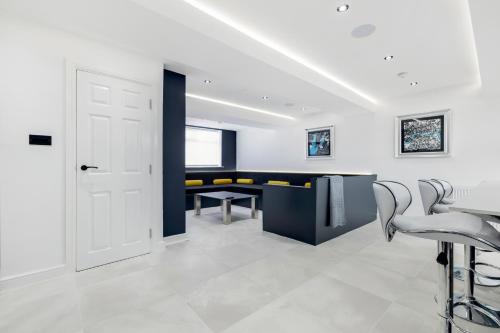 a white room with a table and chairs at Wellington Suites by Sasco Apartments in Blackpool