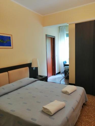 a bedroom with a bed with two pillows on it at Hotel Palace in Varazze