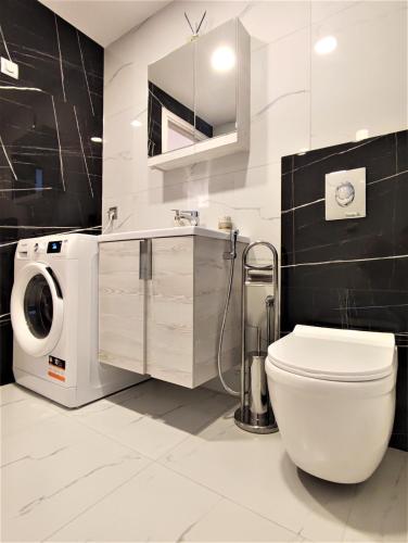 a bathroom with a toilet and a washing machine at Villa Pavlina in Ixia