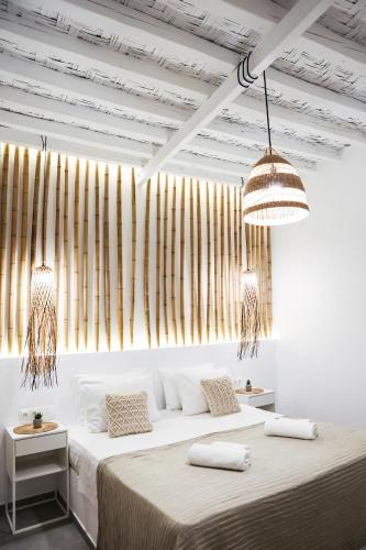two beds in a white room with two lamps at PS House Kimolos - Ps Rental in Kimolos