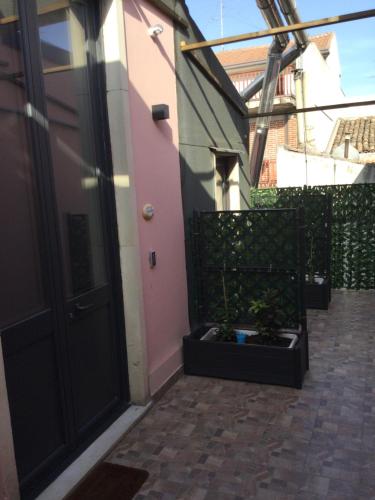 a door to a house with a plant in a planter at B&B Affittacamere Trigona in Misterbianco
