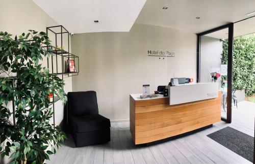 a salon with a chair and a reception desk at Hotel do Paço By VimaHotels in Guimarães