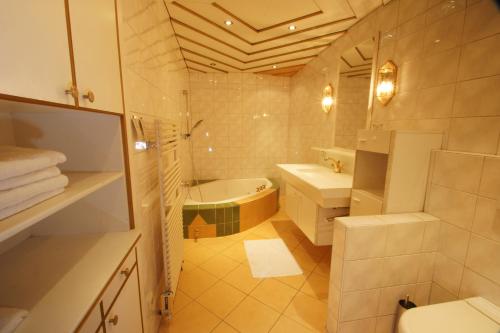 ein Badezimmer mit einer Badewanne, einem WC und einem Waschbecken in der Unterkunft Gasthof zur Post in Strasswalchen