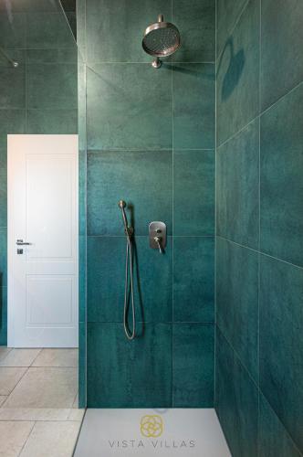 a bathroom with a shower with green tiles at Vista Villas - Sweet Life Apartment Villa S in Ražanac